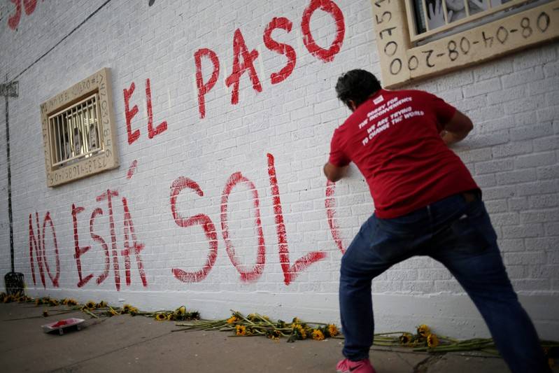 A man takes part in a rally against hate a day after a mass shooting at a Walmart store in El Paso Texas U.S. August 4 2019. Graffiti reads quotEl Paso Is Not Alonequot REUTERSJose Luis Gonzalez