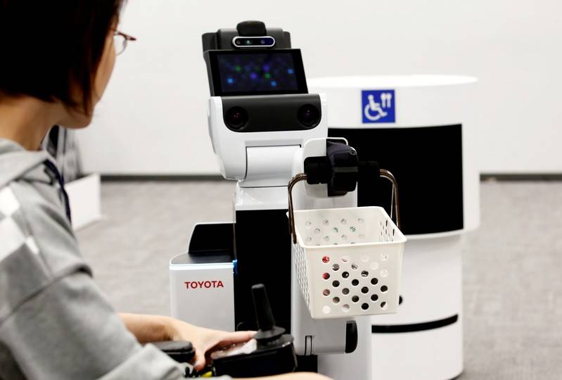 FILE PHOTO Toyotas HSR Human Support Robot delivers a basket to a woman in a wheelchair at a demonstration of Tokyo 2020 Robot Project for Tokyo 2020 Olympic Games in Tokyo Japan March 15 2019. REUTERSKim Kyung-hoonFile Photo