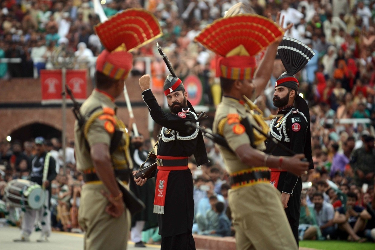 Indian Border Security Force personnel (wearing brown) and Pakistani Rangers (wearing black) taking part in the Beating Retreat ceremony on India's Independence Day last month. - AFP