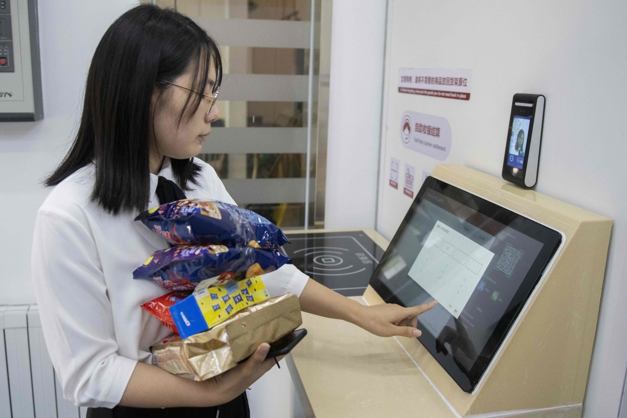 A woman buying groceries at an IFuree Go self-service supermarket in Tianjin.