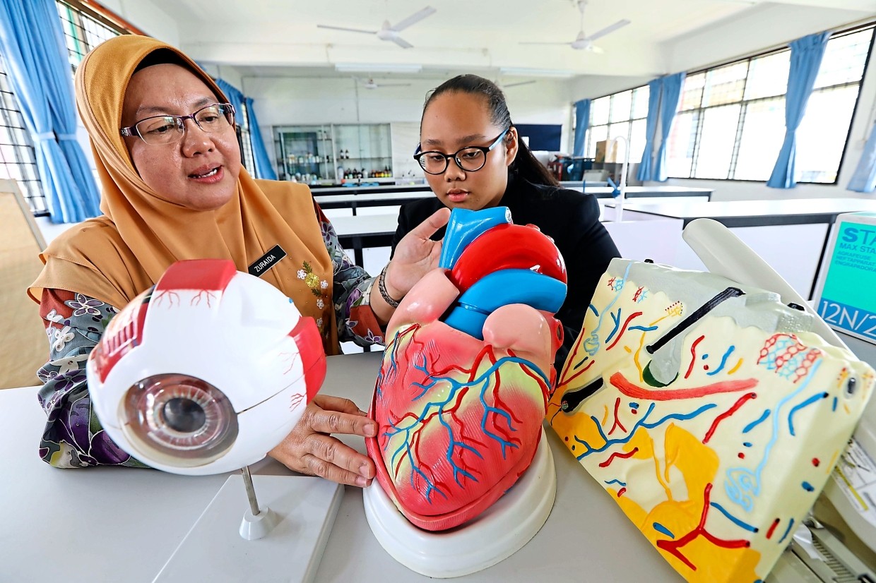 SMK Lundu student Bruchel likes the interactive aspects of learning introduced by the trust school programme, which senior assistant  Zuraida said also provided teachers support in conducting lessons.  —Photos by ZULAZHAR SHEBLEE/The Star
