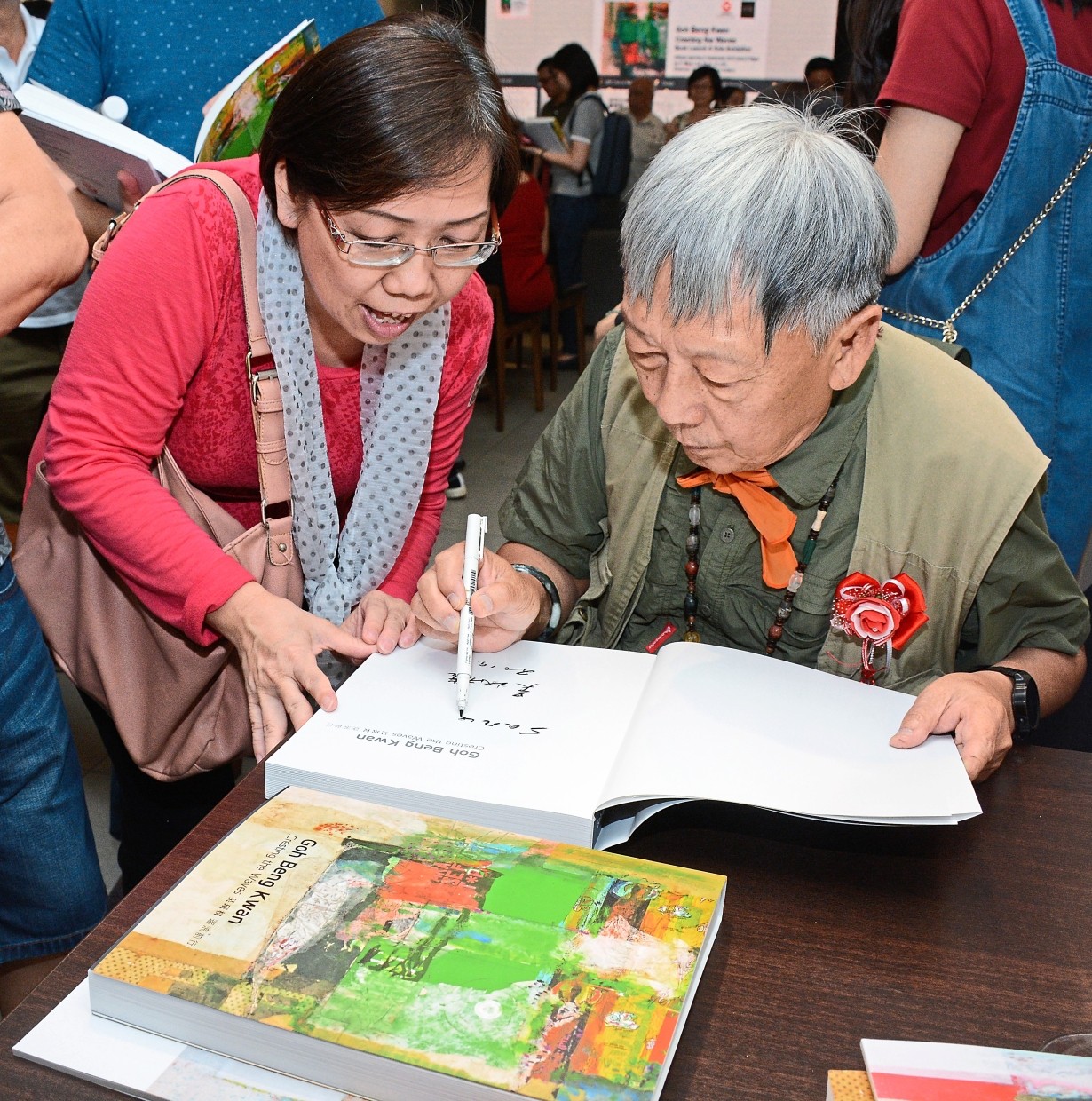 Goh (right) autographing copies of the book for art lovers.