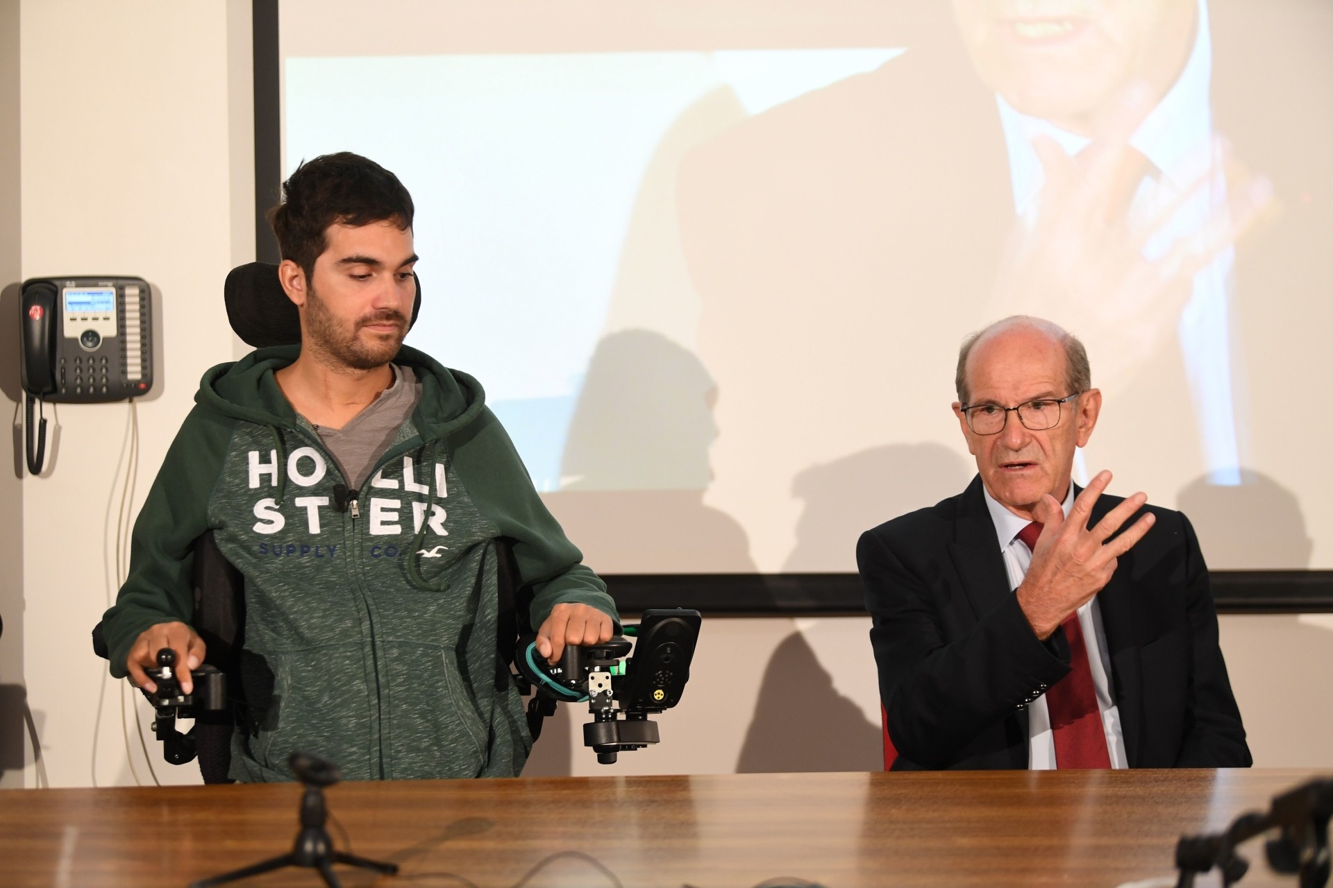 French doctor Alim Louis Benabid (right) and patient Thibault attending a press conference to present the brain-controlled exoskeleton that allowed the patient to walk again at the biomedical research centre Clinatec in Grenoble on Oct 7, 2019. A French man paralysed in a night club accident can walk again thanks to a brain-controlled exoskeleton in what scientists said was a breakthrough providing hope to tetraplegics seeking to regain movement. — AFP