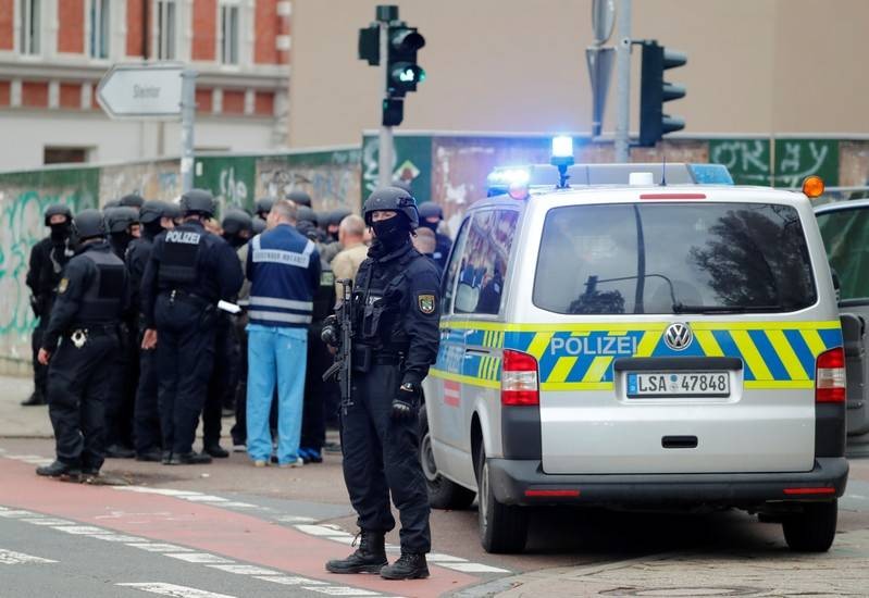 A police officer stands guard next to a police car near the site of a shooting in which two people were killed in Halle Germany October 9 2019.   REUTERSFabrizio Bensch