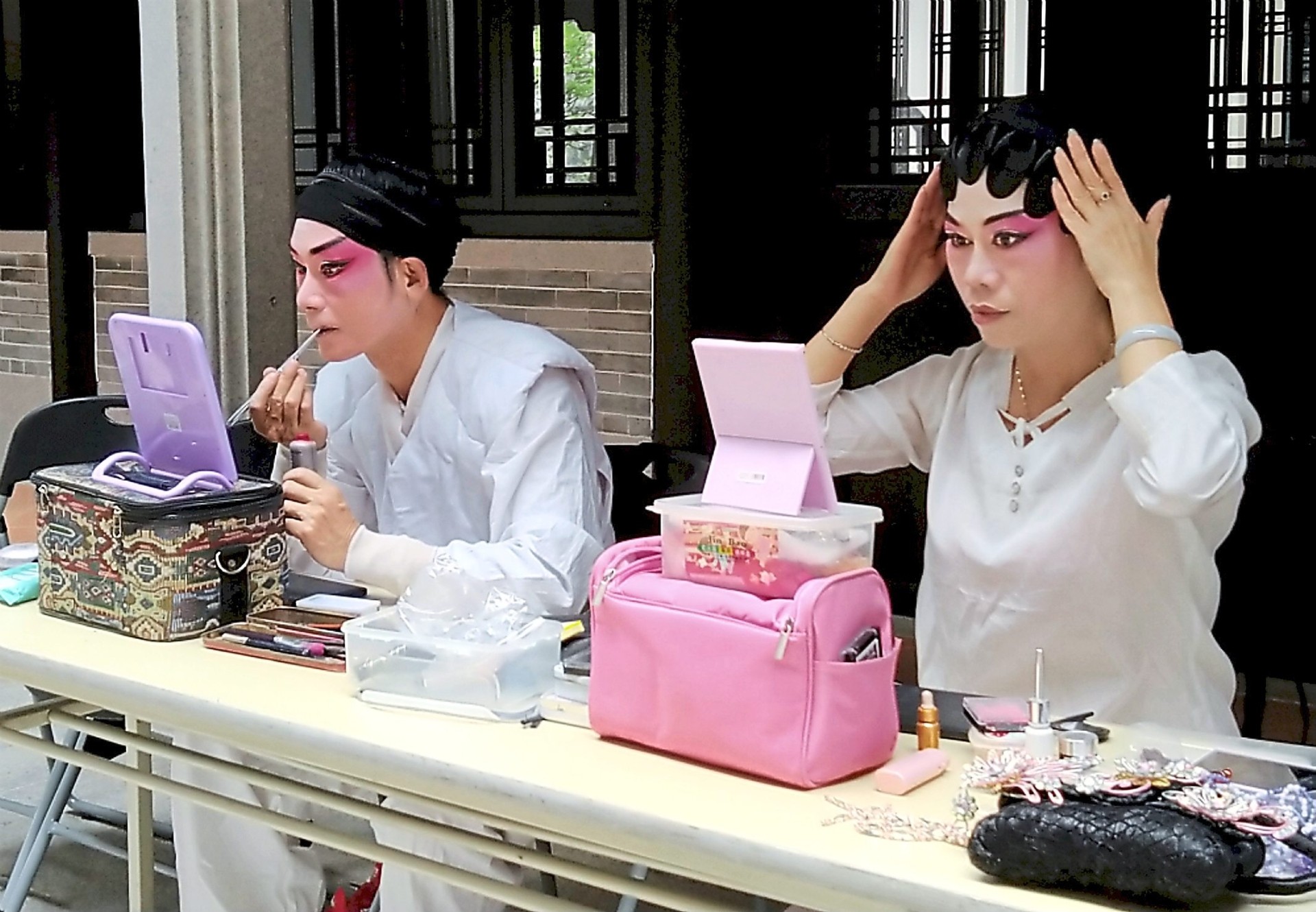Looking good: Ye and Li putting on make-up and headgear before their performance.