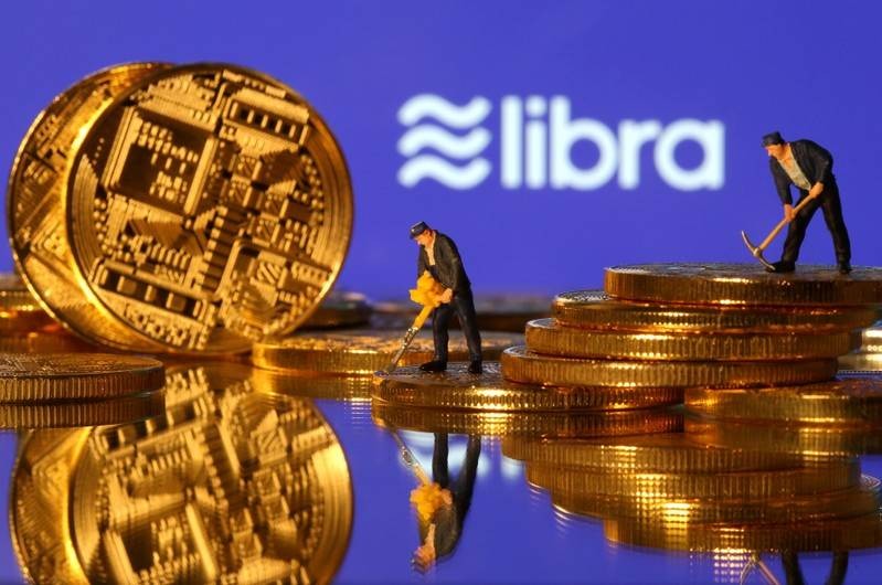 FILE PHOTO FILE PHOTO Small toy figures are seen on representations of virtual currency in front of the Libra logo in this illustration picture June 21 2019. REUTERSDado RuvicFile Photo