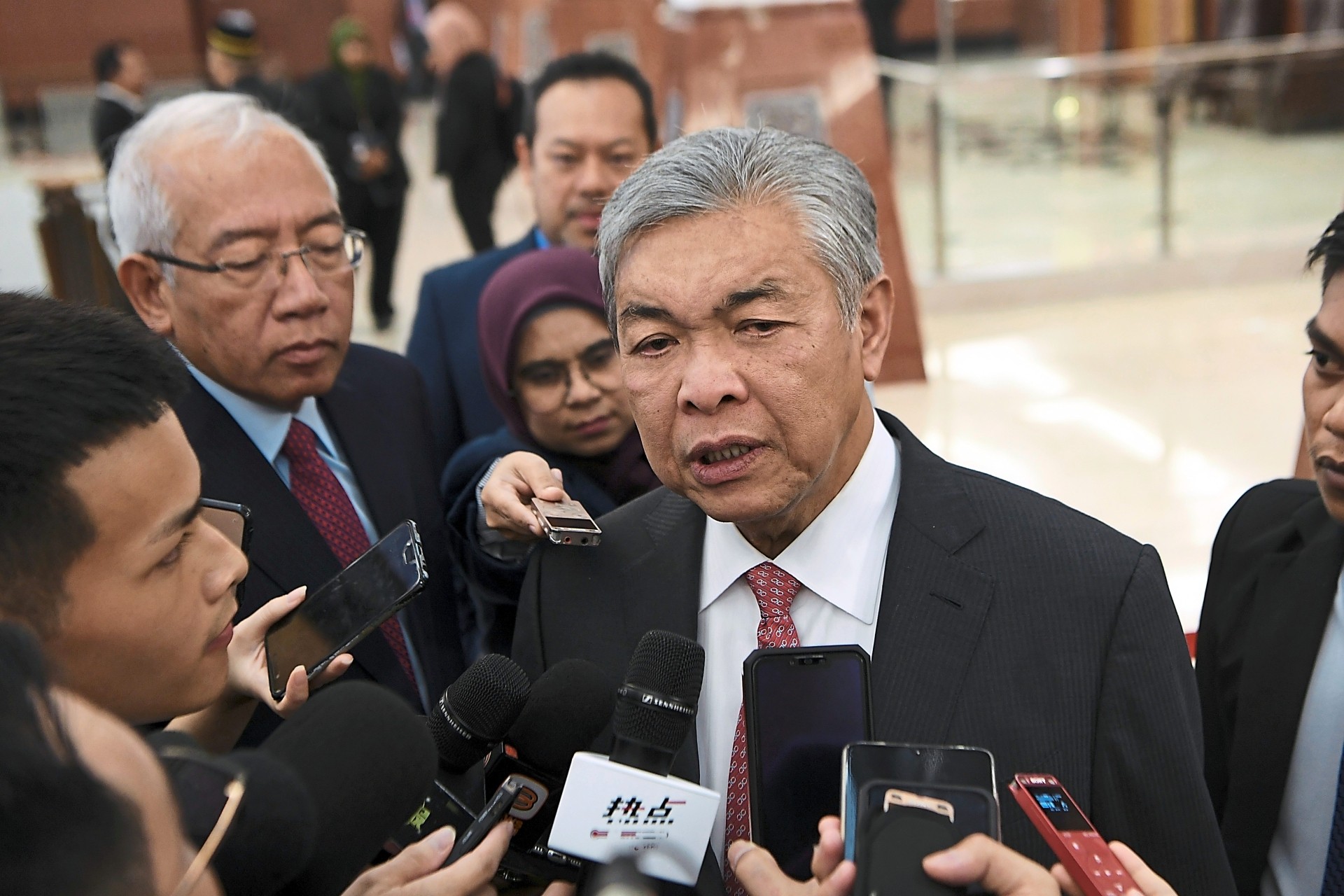 Q&A time: Dr Ahmad Zahid talking to reporters at Parliament lobby. — Bernama