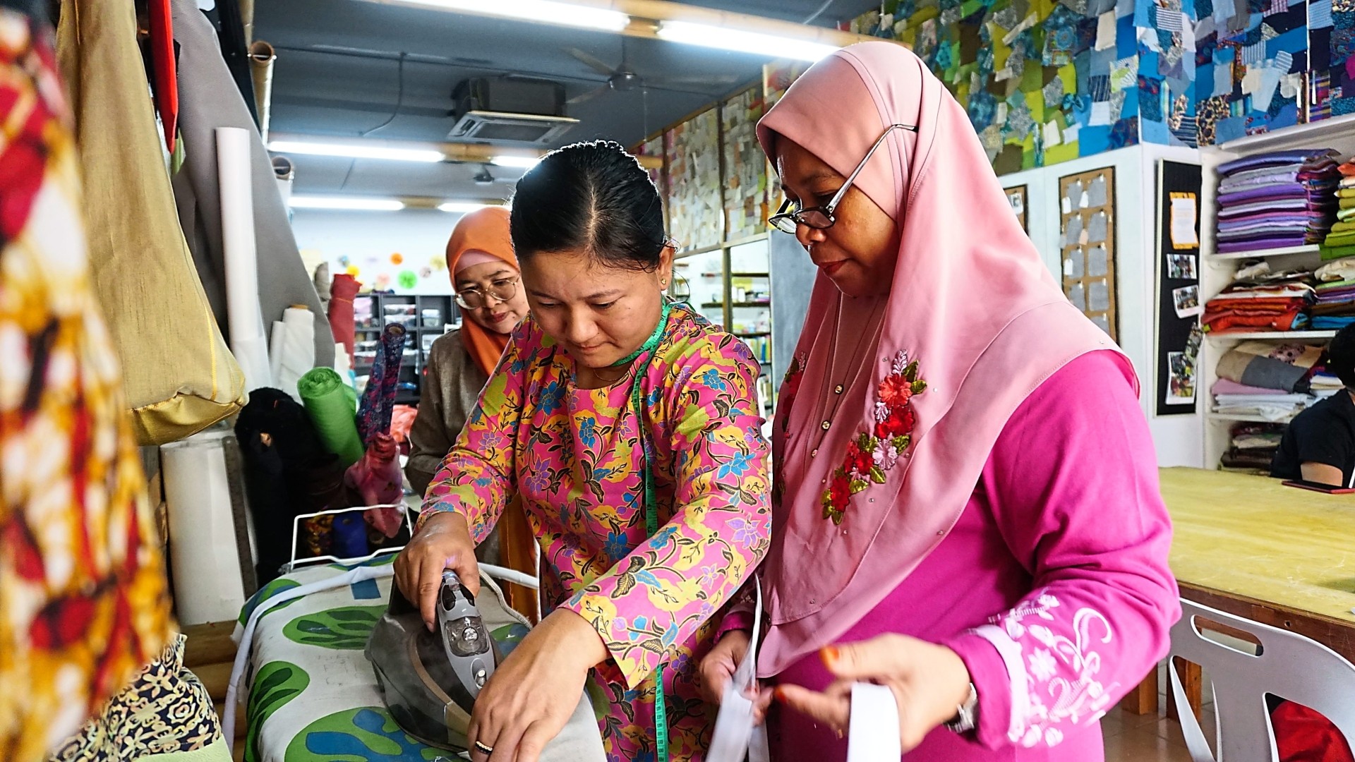Sew x Dignity staff guiding Kain Movement’s talents during one of the sewing workshops.