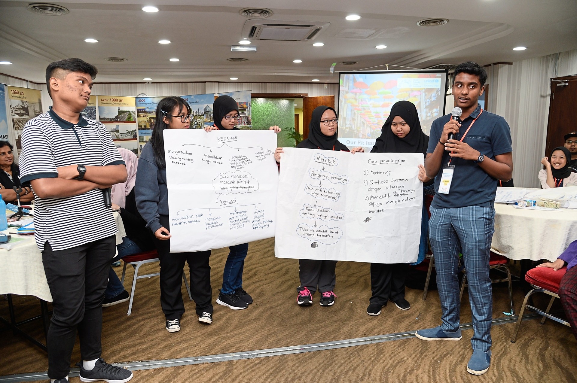 Kirtti Kesavan (right), who says adults should make a point to listen to children, presenting his views on smoking during a workshop.