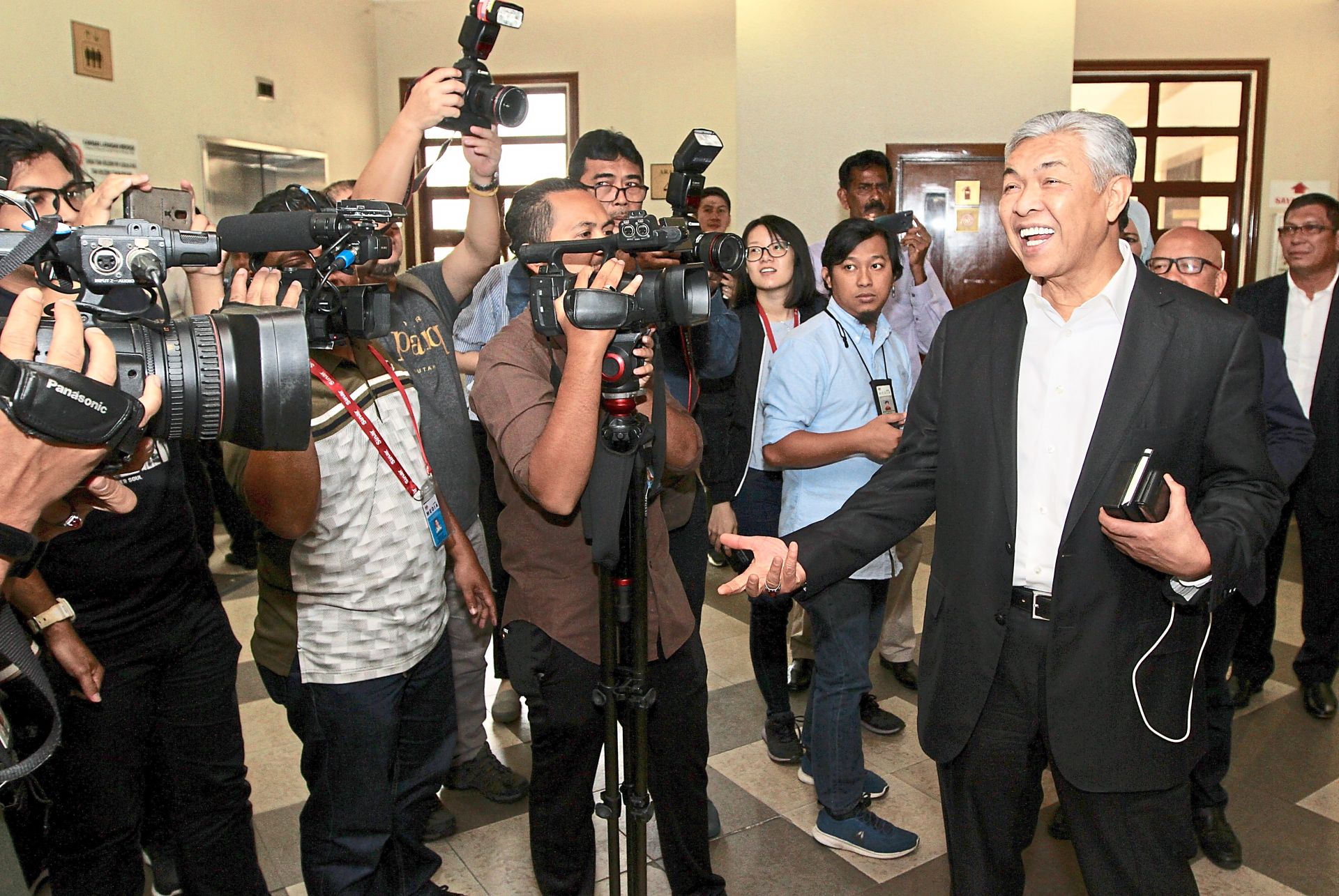 Jovial talk: Ahmad Zahid chatting with the media during a break at the Kuala Lumpur High Court.
