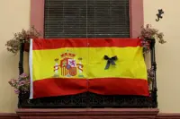 With black masks and silence, Spain mourns its coronavirus dead