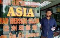 Barbers preparing to open business by disinfecting shops