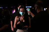 Masks and bikinis as Bangkok sex districts reopen with new rules