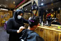 First woman working at the barbers of Babylon shrugs off abuse