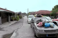 Heaps of rubbish dumped on cars double-parked by mechanic