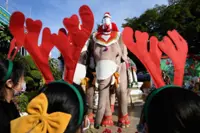 Santa rides elephants to Thai town, bearing gifts of face masks