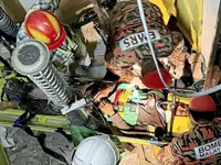 Worker survives fall in elevator shaft