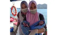 Health workers help deliver twins on ambulance boat