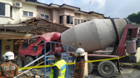 Faulty brakes cause cement mixer lorry to crash into two houses