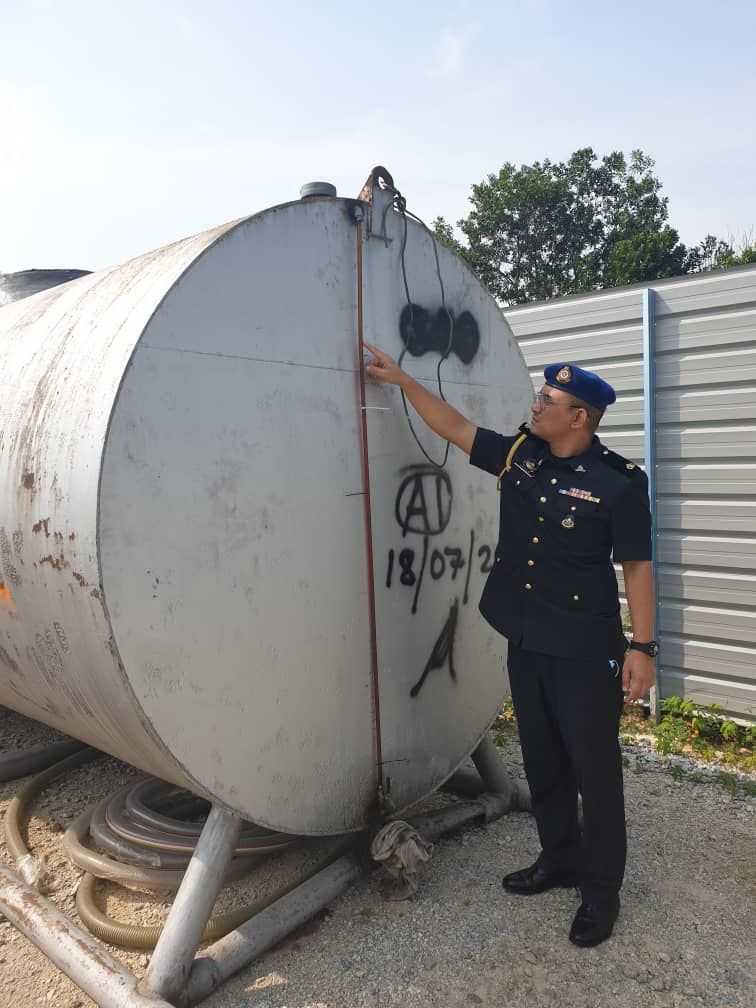  An enforcement officer checking a tank believed to have also been used to store the subsidised diesel.