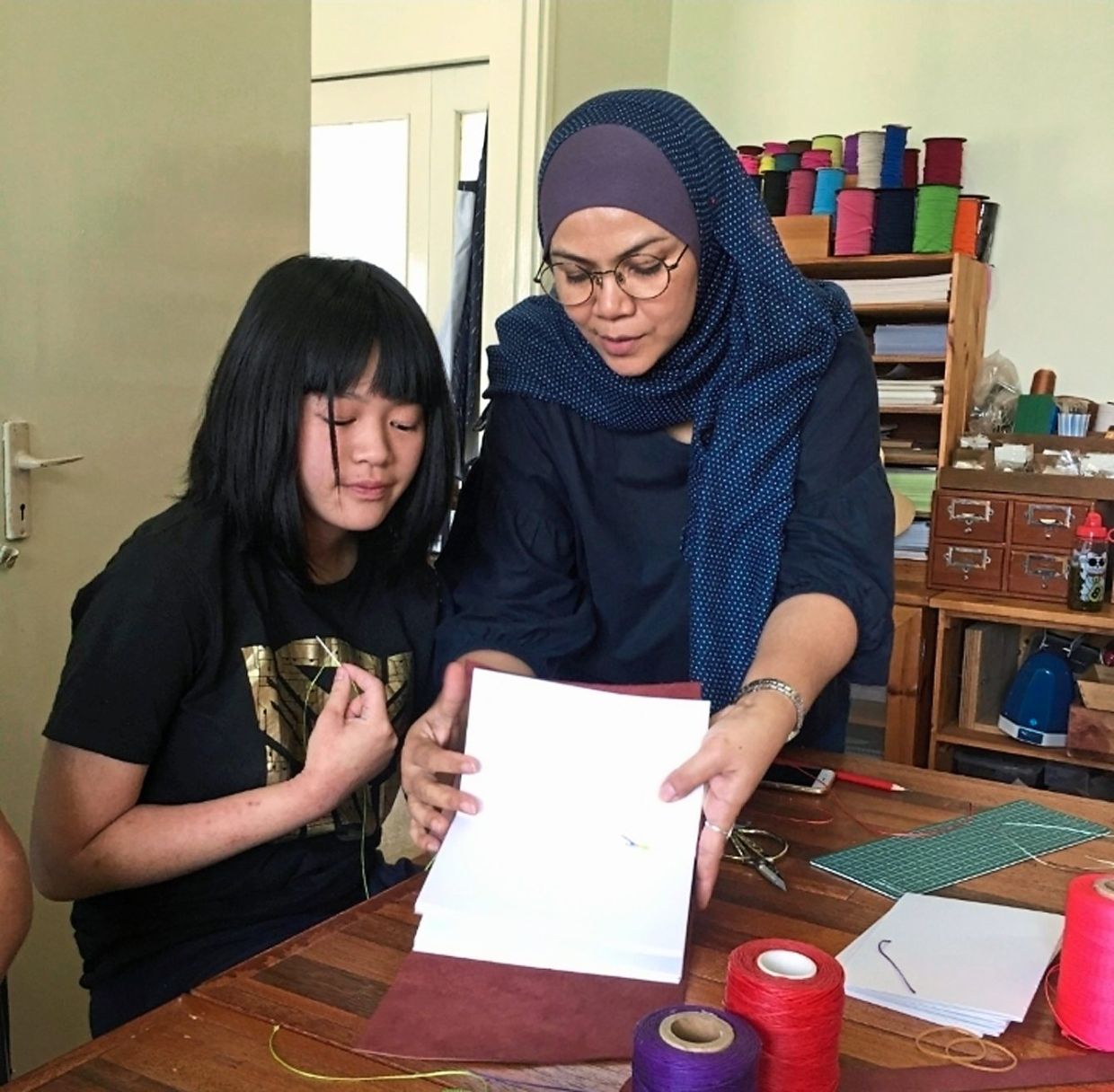 Samsiah has shared her knowledge in bookbinding with over 2,000 students in the last decade.