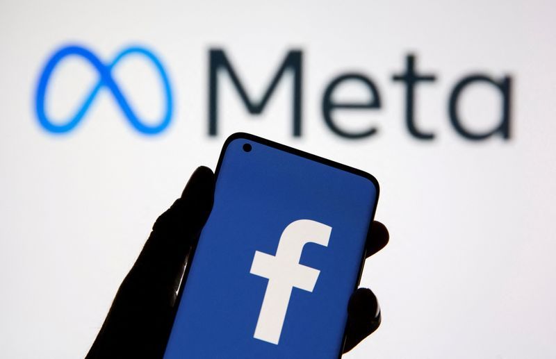 FILE PHOTO A smartphone with Facebooks logo is seen in front of displayed Facebooks new rebrand logo Meta in this illustration taken October 28 2021. REUTERSDado RuvicIllustration