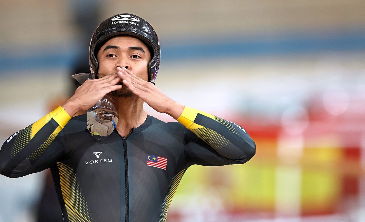 A kiss for luck: Azizul regularly keeps in touch with the Birmingham-bound cyclists.