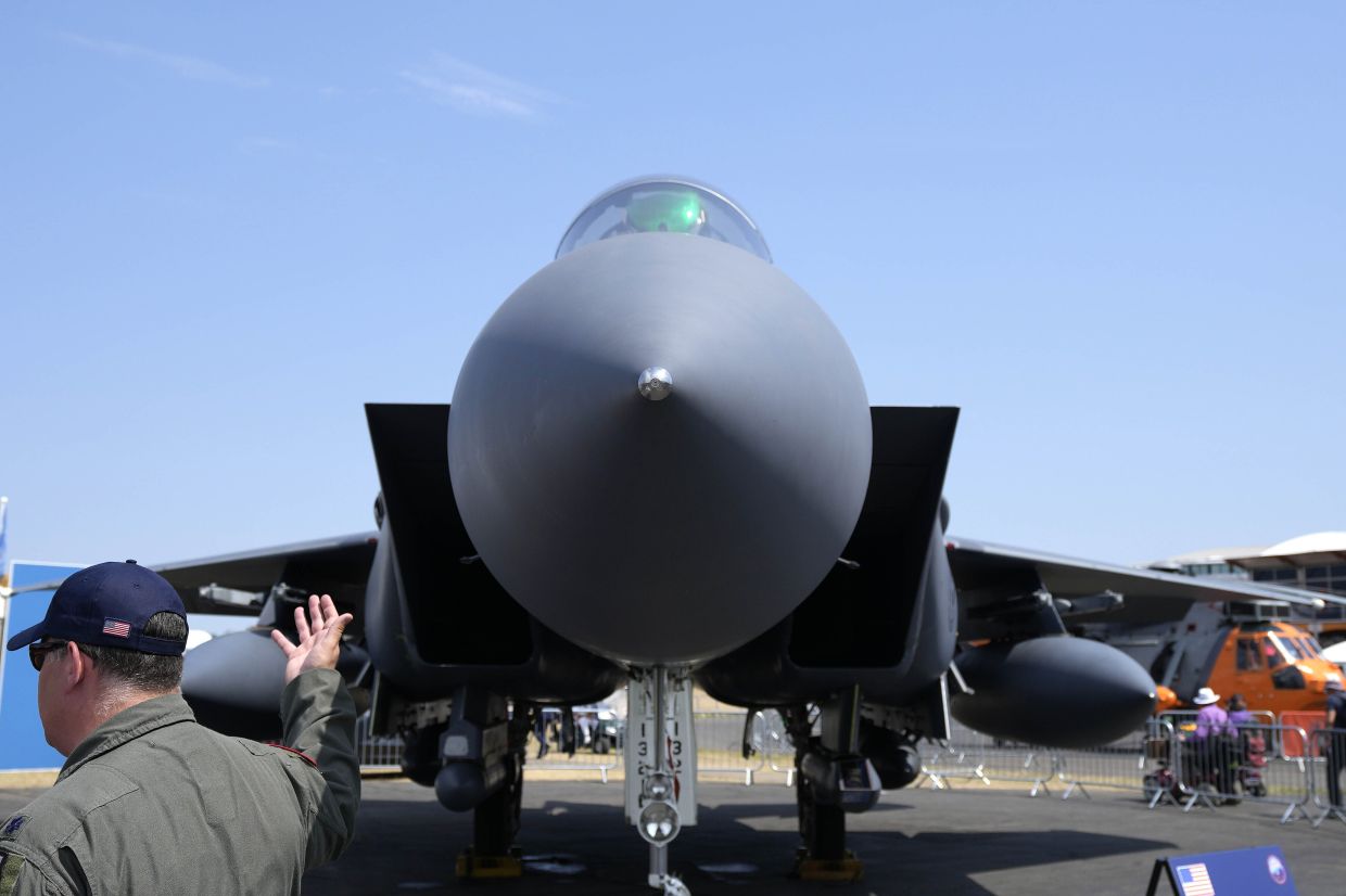 A F-15E Strike Eagle fighter jet is on display at the Farnborough Air Show fair in Farnborough, England. The future for fighter pilots was on display at the Farnborough International Airshow near London, one of the world’s biggest aviation, defense and aerospace expos. New technologies take on a bigger role in the cockpit, redefining what it means to be a 'Top Gun'. — AP