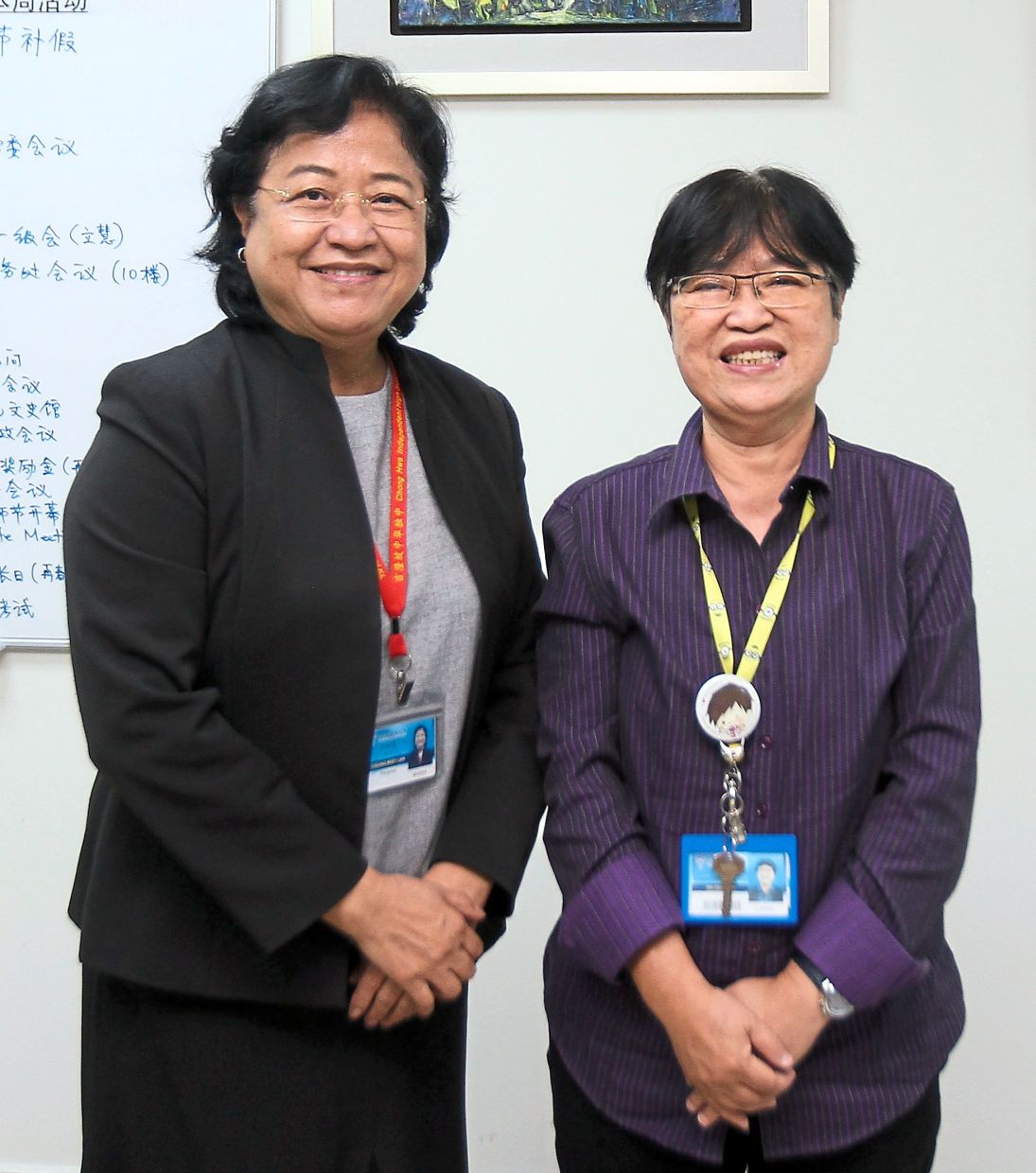 Cheong (left) and Choon Moi use newspapers to expand the students’ world view and expose them to current affairs.