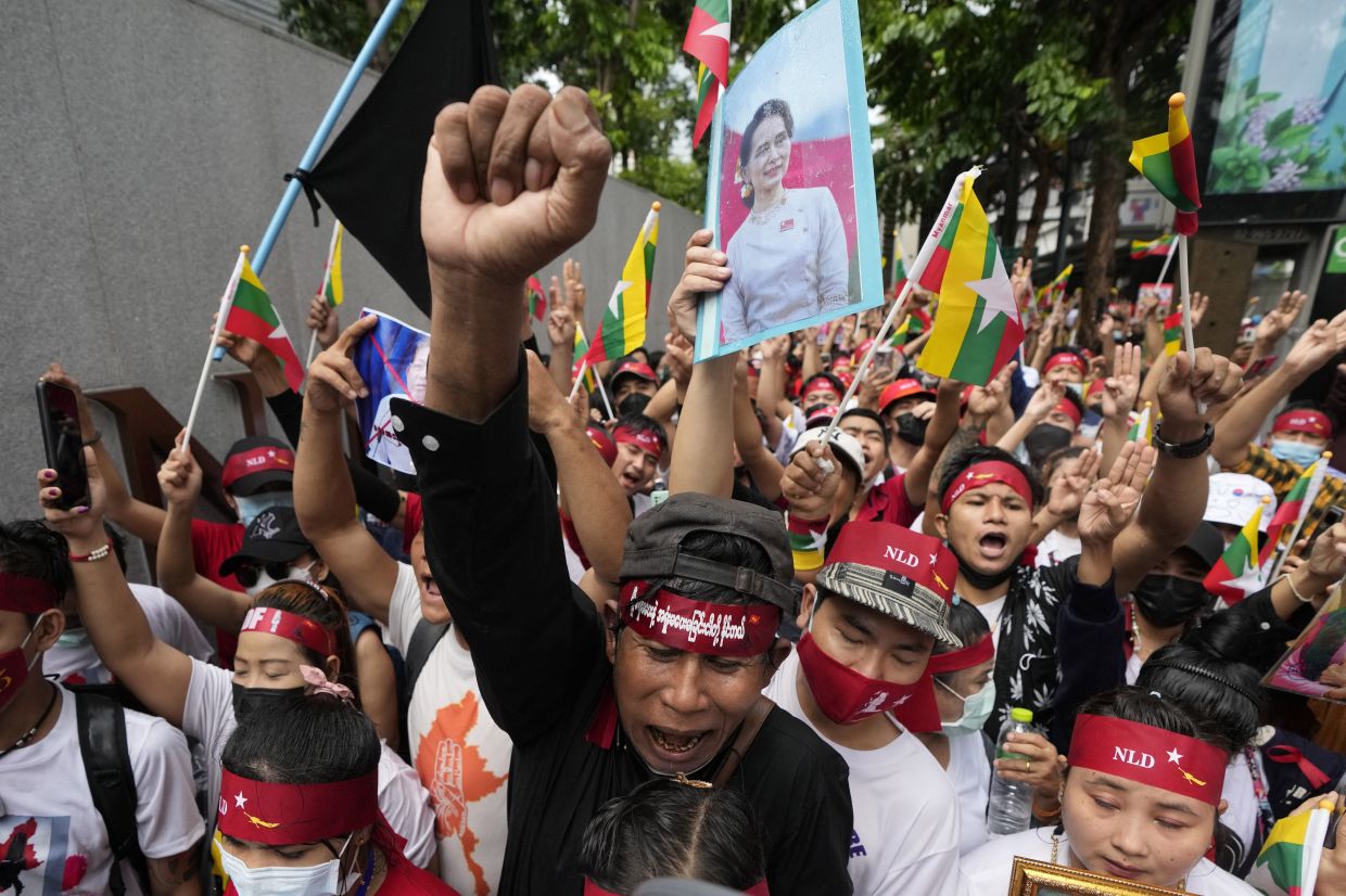 Myanmar nationals living in Thailand with a picture of deposed Myanmar leader Aung San Suu Kyi, seen at center, stage a rally outside Myanmar's embassy in Bangkok, Thailand, Tuesday, July 26, 2022. International outrage over Myanmar’s execution of four political prisoners is intensifying with grassroots protests and strong condemnation from world governments. - AP