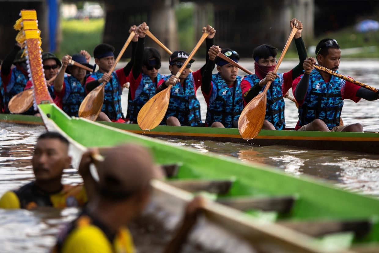Competitors race during the annual Thai long tail boat races, a traditional sporting event at a canal in Ban Mee, Lopburi province, Thailand. - Reuters