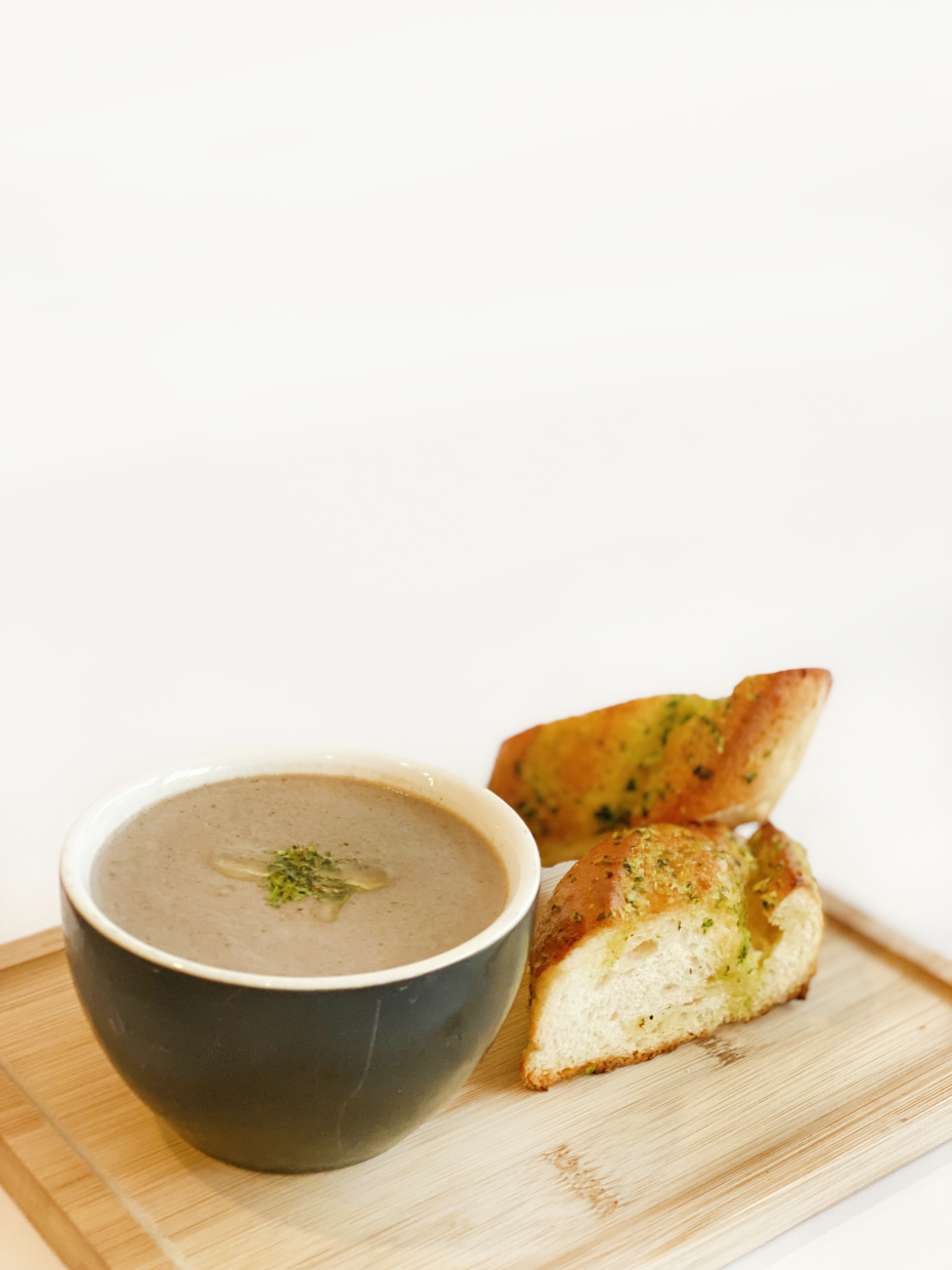 The mushroom soup is thick and filled with mushrooms.