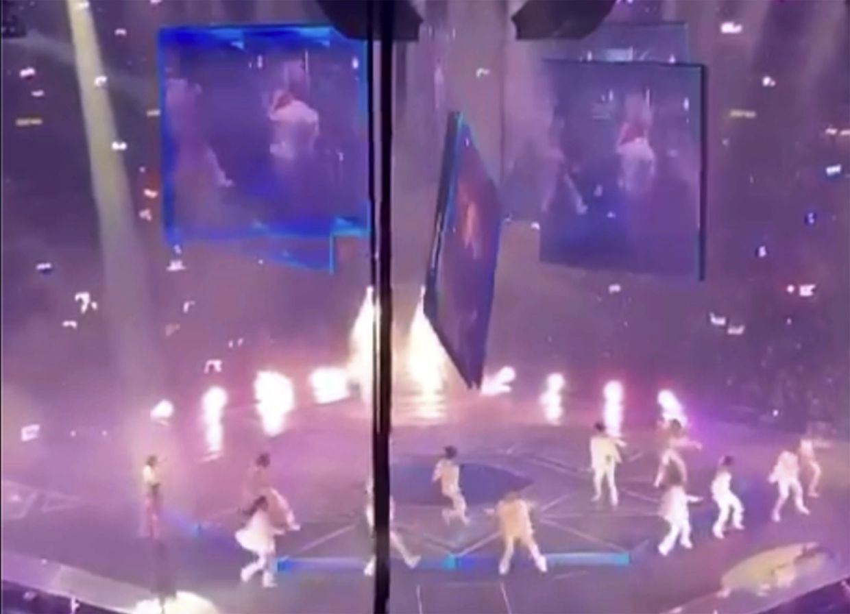 In this image made from video taken from social media, a massive video screen suspended above the stage fells onto performers at a concert of Cantopop boy band Mirror, in Hong Kong, Thursday, July 28, 2022. Photo: AP