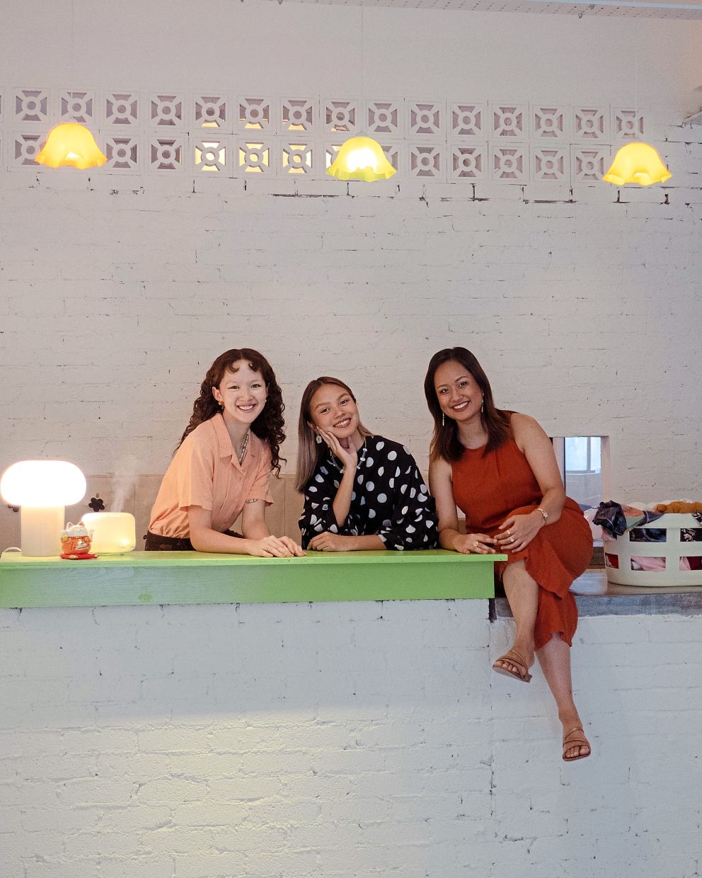 (From left) Former colleagues Bay Doucet, Emma Khoo and Adani Bakhtiar wanted to help rehome good quality pre-loved clothing. Photo: Looop
