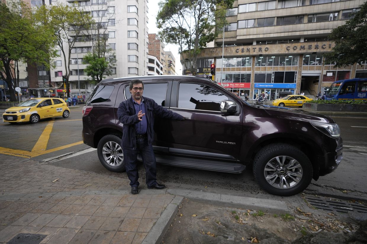 Yepes talks next to his government assigned SUV, during an interview in Bogota, Colombia. Yepes is concerned that cellular circuitry he discovered in the vehicle in September could be used to illegally eavesdrop on conversations. — AP