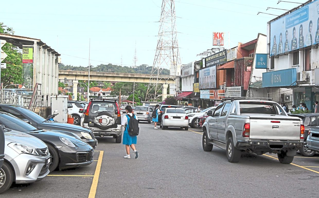 Some parents park for two hours in front of shops just a road away from the school in Section 10, causing inconvenience for business owners