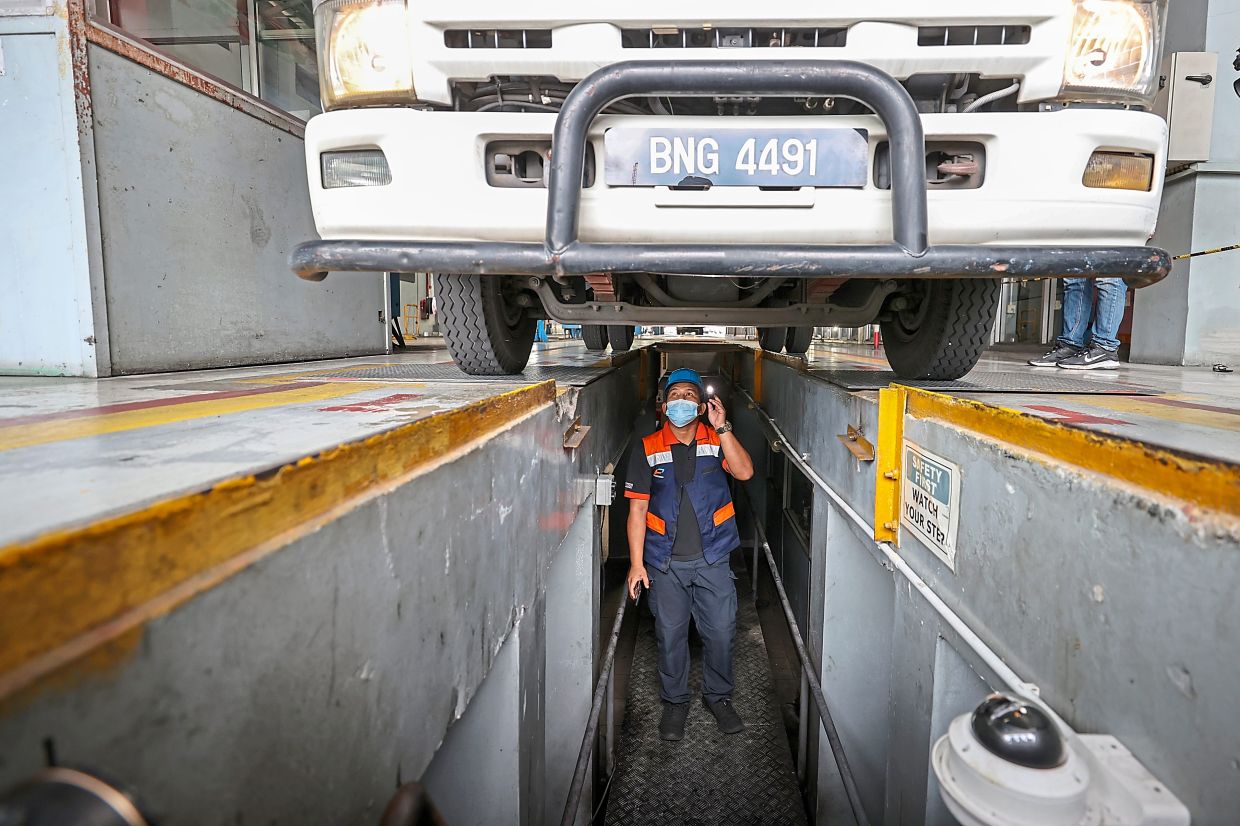 Stringent checks: A Puspakom officer conducting vehicle inspection at the centre in Kuala Lumpur. — GLENN GUAN/The Star