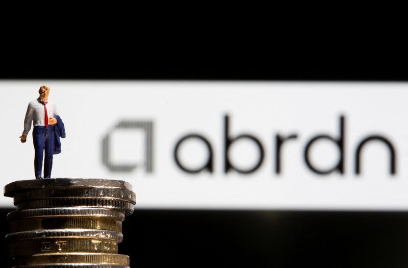 FILE PHOTO Businessman toy figure is placed on U.K. Pound coins in front of displayed Abrdn logo in this illustration taken November 8 2021. REUTERSDado RuvicIllustration
