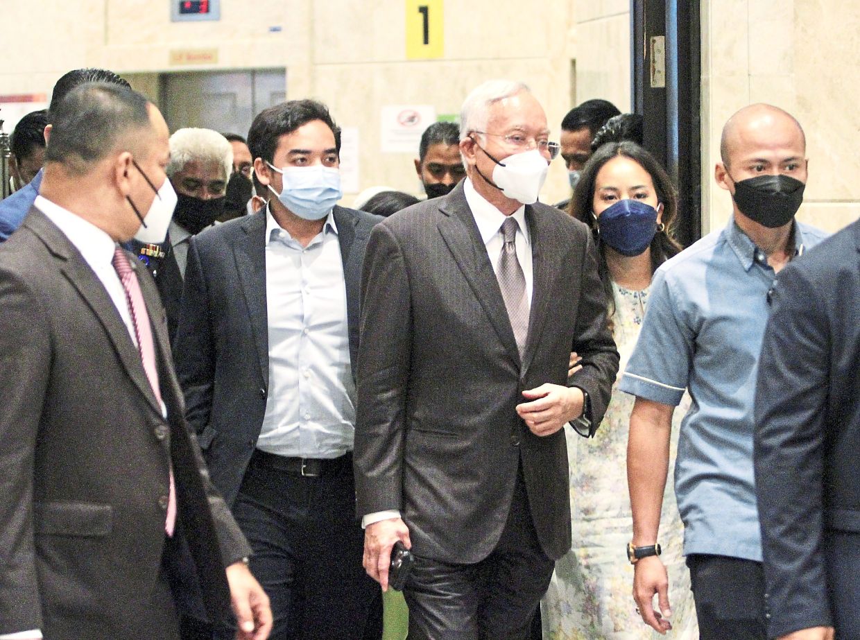 Family support: Najib walking with his children Norashman and Nooryana Najwa during a break from the appeal hearing in the SRC International case. — LOW BOON TAT/THE STAR