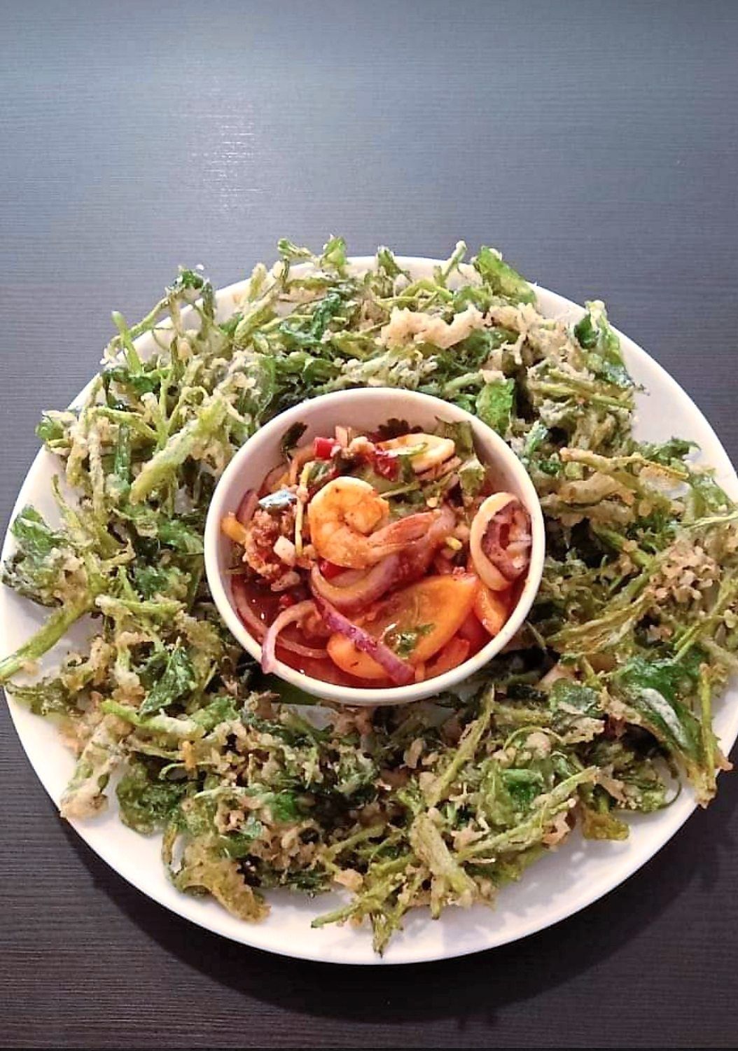 The crispy kangkung is an unusual dish that is served with a spicy seafood gravy.