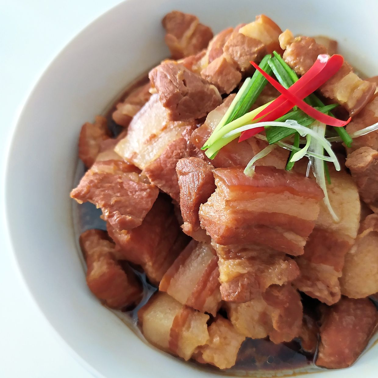 The soy sauce pork belly features tender pork juxtaposed against a sauce that is incredibly good.