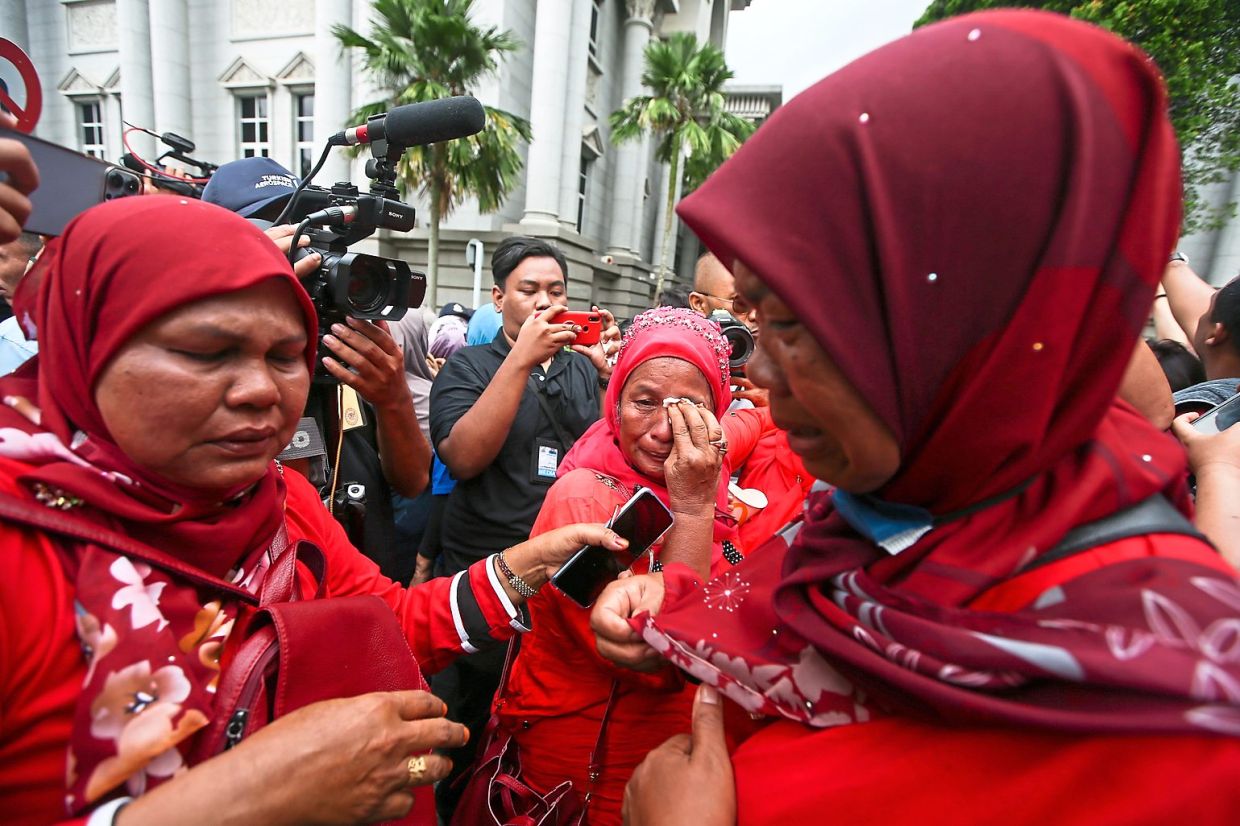 Tears of fear: Najib’s supporters crying after listening to his short speech outside the Palace of Justice before the verdict. — IZZRAFIQ ALIAS/The Star