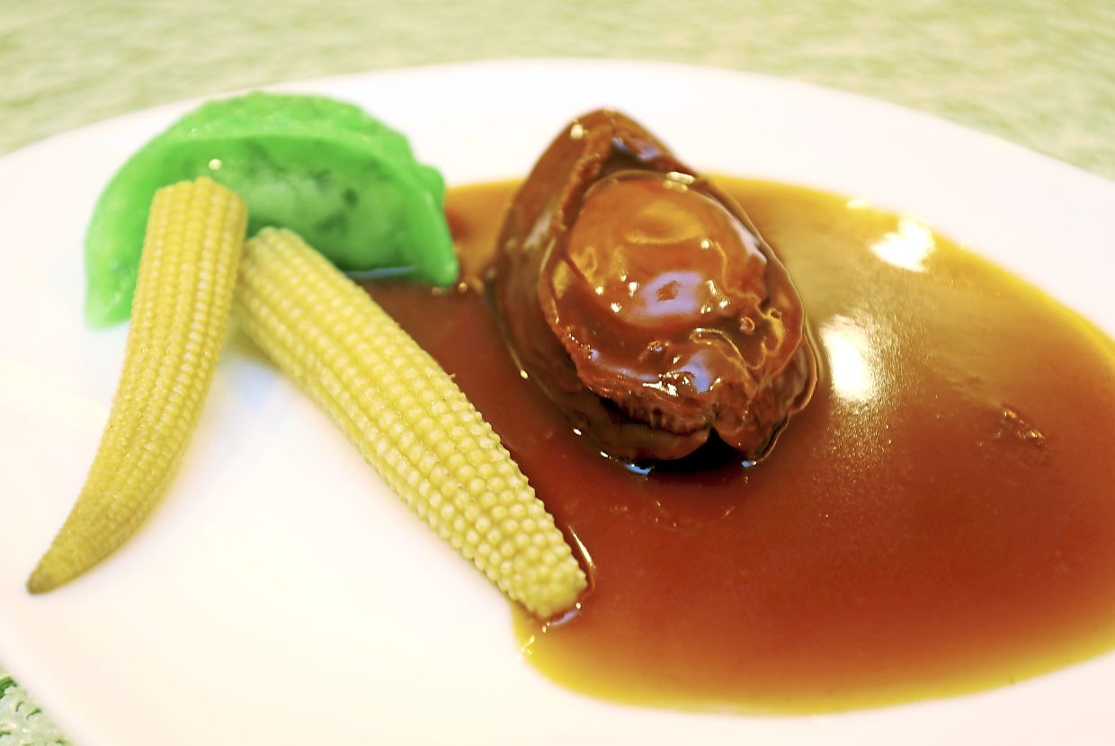Abalone with a chive and prawn dumpling, baby corn and a thick, hearty sauce.