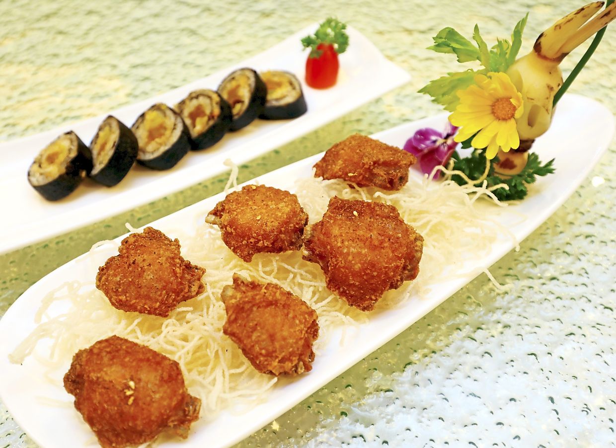 Otak-otak sushi rolls (background) and garlic-fried chicken wings.