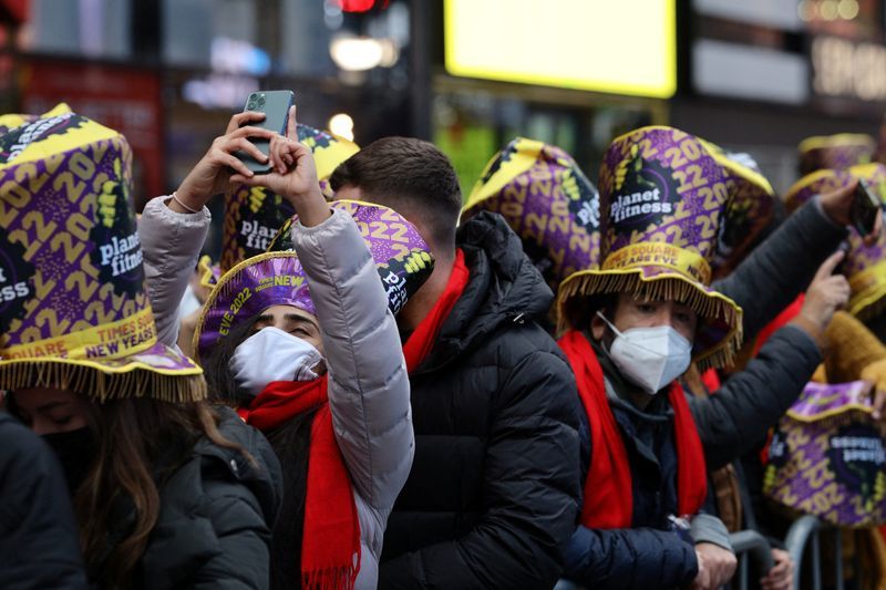 A person uses a mobile phone as the crowd grows in Times Square ahead of New Years Eve celebrations as the Omicron coronavirus variant continues to spread in the Manhattan borough of New York City U.S. December 31 2021. REUTERSStefan Jeremiah