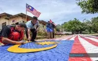 Kampung Bukit Kechik villagers weave 35-metre Jalur Gemilang flag