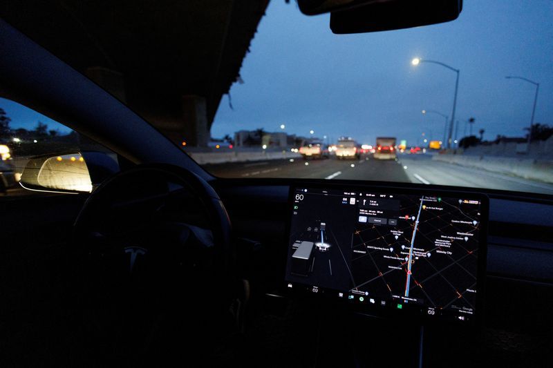 FILE PHOTO A Tesla Model 3 vehicle drives on autopilot along the 405 highway in Westminster California U.S. March 16 2022. REUTERSMike Blake