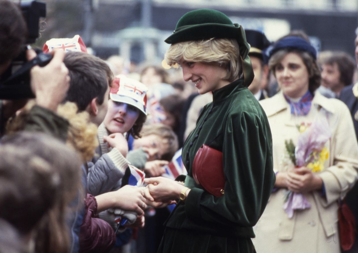 Princess Diana shakes hands and talks to school children during her visit to a new shopping centre at Aylesbury, Bucks., England in 1983. 