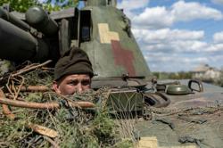 Ukraine troops say they take key town, Putin ally mulls possible nuclear response