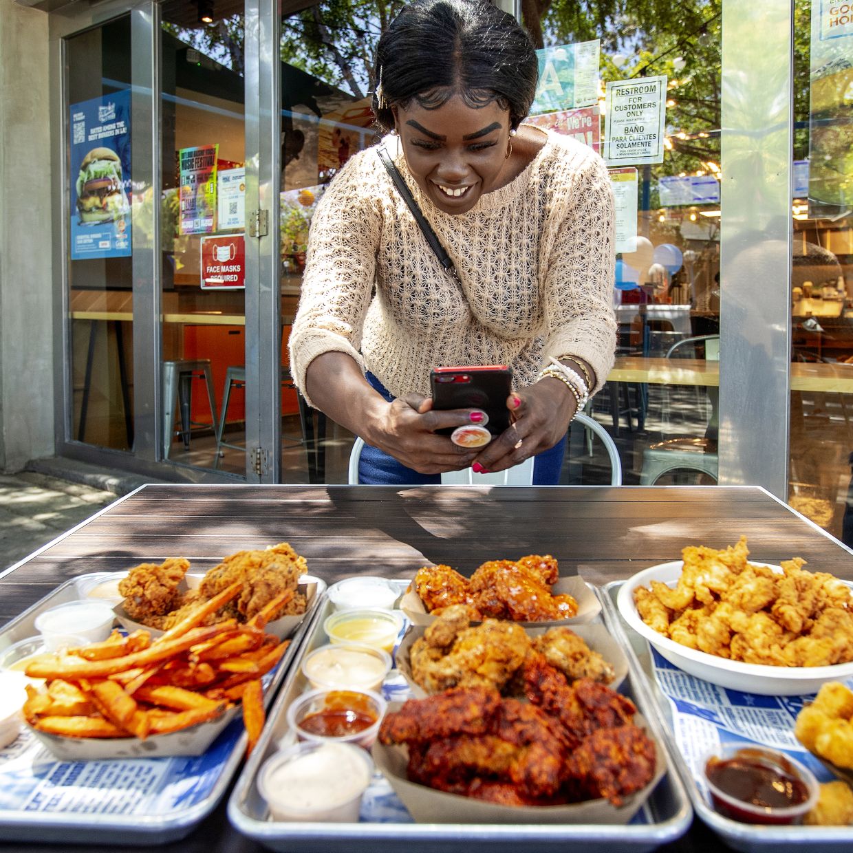 Ahaiwe filming content at the West Hollywood location of Hollywood Burger. — Los Angeles Times/TNS